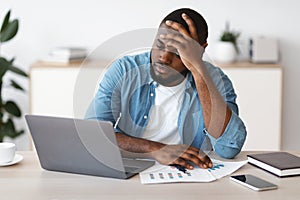 Lack Of Inspiration. Stressed Black Freelancer Guy Sitting At Desk With Laptop