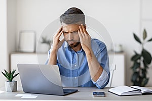 Lack Of Inspiration. Thoughtful Businessman Looking Focused On Laptop Screen In Office