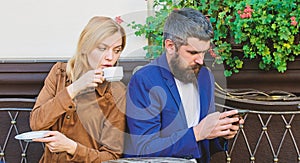 Lack of live communication. First meet of girl and mature man. woman and man with beard relax in cafe. Brutal bearded