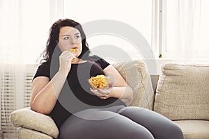 Fat woman overeating junk food. sedentariness