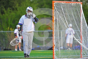 Lacrosse Goalie wiping his face