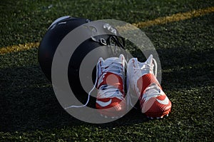 LACROSSE SHOES AND HELMET SIT AT THE READY