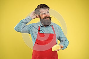 Lactose. Gourmet product. Cheesemaking concept. Cheese maker. Bearded man in apron hold piece cheese. Dairy product