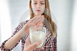 Lactose intolerance. Dairy Intolerant young girl refuses to drink milk