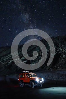 Ladakh, India - August 24th, 2022: Extreme long exposure image showing Milkyway Galaxy over an SUV offroad vehicle in the