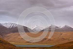 Ladakh landscape with snowy mountains and a long thread of buddhist flags