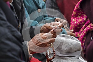 Ladakhi holding wooden rosary beads