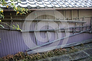 A ladder hanging on a galvanized iron wall