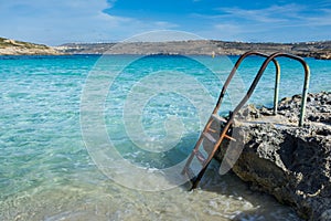 Ladder leading down into a beautiful blue sea