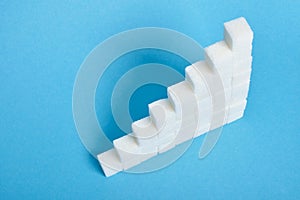 Ladder made of sugar on a blue background