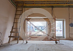 Ladder in the mirror and parts of scaffolding during on the remodeling, renovation and construction of apartment