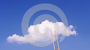 Ladder reaches the white cloud on the blue sky.