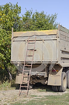 Ladder at the rear of a dump truck on the side of the road