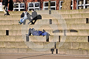 On a ladder resting unknown people.