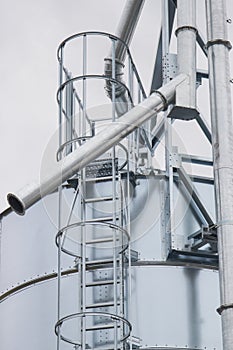 Ladder on silo for storage grain after harvest. Detail of agricultural equipments