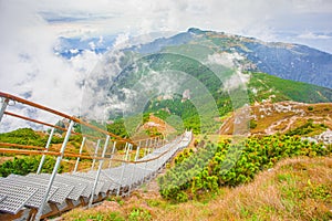 Ladder with stairs in the beautiful mountain landscape. Ceahlau, Toaca. photo