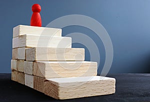 Ladder of success from wooden blocks. Ambitions and achievements
