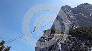 Ladder between two rock mountains on via ferrata Donnerkoge lin Austrian Alps