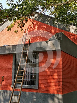 ladders against red brick house