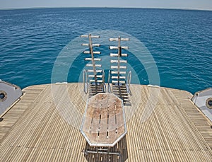 Ladders on the back wooden deck of a luxury motor yacht