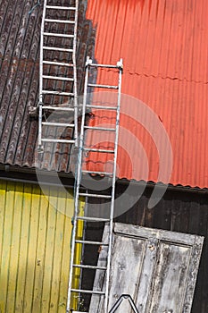 Ladders on painted tin roof.