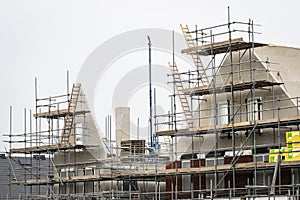 Ladders and scaffolding of houses under construction