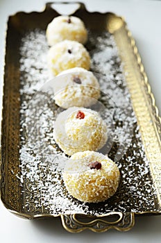 Laddu - coconut bites made of khee, coconut flakes, spices