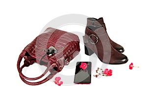 Ladies bag, ankle boots, mobile phone and jewelry isolated on white