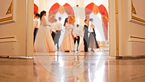 Ladies with cavaliers in vintage costumes dancing waltz photo