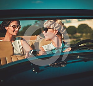 Ladies in a classic convertible