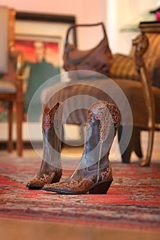 Ladies cowboy boots sitting on a red carpet