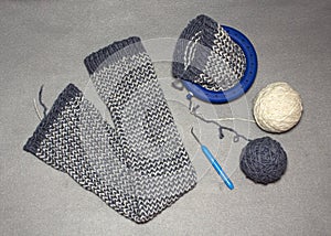 Ladies ` knitted gaiters from gray-white acrylic