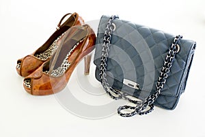 Ladies Leather blue handbag and brown color of high heel shoes i