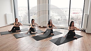 Ladies meditating in seated pose with hands in anjali mudra