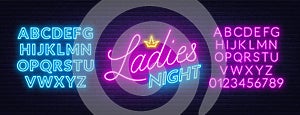 Ladies Night neon lettering on brick wall background. photo