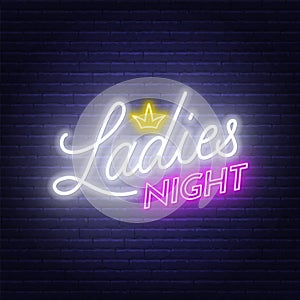 Ladies Night neon lettering on brick wall background. photo