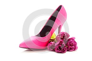 Ladies pink high heel shoe and tulips on white, concept female,