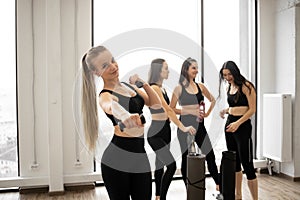 Ladies in yoga clothes spending time together in sports club