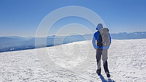 Ladinger Spitz - Man hiking in snow covered landscape on Saualpe, Lavanttal Alps, Carinthia, Austria, Europe. View Karawanks