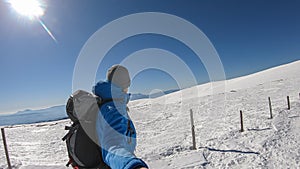 Ladinger Spitz - Man hiking in snow covered landscape on Saualpe, Lavanttal Alps, Carinthia, Austria, Europe. View Karawanks