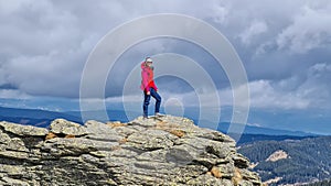 Ladinger Spitz - Smiling woman standing on massive rock formation at Steinerne Hochzeit, Saualpe, Lavanttal Alps, Austria photo