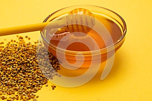 A ladle of honey on the background of a honeycomb of a bee. Honey tidbit in a glass jar honey spoon, bee bread and a