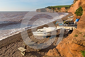 Ladram Bay beach Devon England UK with boats red sandstone rock Jurassic coast