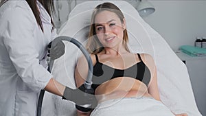 Lady adjusts hair during vacuum cavitation procedure