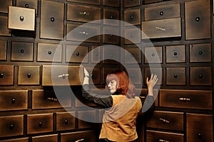 Lady by the antique cabinet