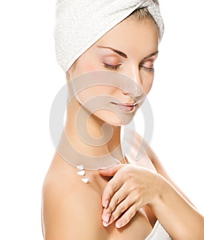 Lady applying moisturizer photo