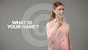 Lady asking what is your name in asl, text on background, communication for deaf