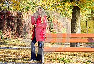 Lady attractive fashionista posing in jacket. Woman fashionable blonde with makeup stand in autumnal park. Jacket for