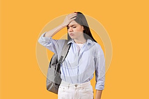 Stressed lady student with hand on forehead in moment of forgetfulness or headache photo