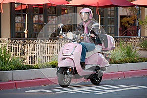 Lady biker on pink scooter